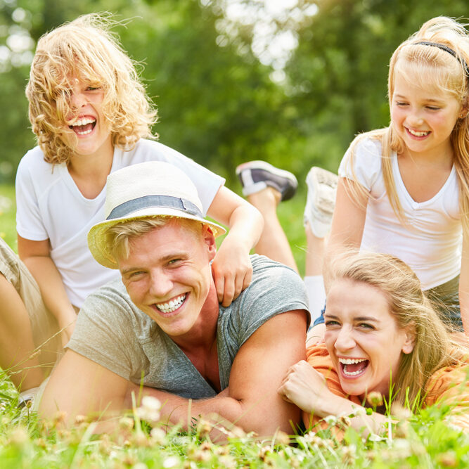 Laughing,Parents,Have,Fun,With,Their,Children,In,The,Garden Laughing,Parents,Have,Fun,With,Their,Children,In,The,Garden